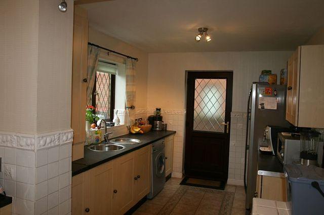 Rear of kitchen. New boxed in units and fridge/freezer on right.